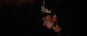 Movie still from “Star Trek V: The Final Frontier” (1989), directed by William Shatner – A person wearing a headpiece; Close Up shot, Over the shoulder angle