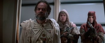 Movie still from “Star Trek V: The Final Frontier” (1989), directed by William Shatner – A man with a beard wearing a white shirt and a man with a beard wearing a white shirt and a man with a beard wearing a white shirt; Medium shot, Over the shoulder angle