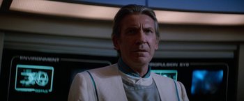 Movie still from “Star Trek V: The Final Frontier” (1989), directed by William Shatner – A person wearing a suit and tie; Close Up shot, Low angle