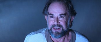 Movie still from “Star Trek V: The Final Frontier” (1989), directed by William Shatner – A person with a beard; Close Up shot, Over the shoulder angle