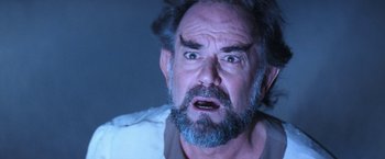 Movie still from “Star Trek V: The Final Frontier” (1989), directed by William Shatner – An old man with a beard and a surprised look on his face; Close Up shot, Low angle