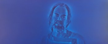 Movie still from “Star Trek V: The Final Frontier” (1989), directed by William Shatner – A man with long hair and a beard is in a blue light; Close Up shot, Low angle