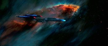 Movie still from “Star Trek: First Contact” (1996), directed by Jonathan Frakes – A space ship flying through the night sky; Extreme Wide shot, Low angle