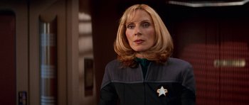 Movie still from “Star Trek: First Contact” (1996), directed by Jonathan Frakes – A woman with a star on her chest; Close Up shot, Over the shoulder angle