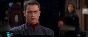 Movie still from “Star Trek: First Contact” (1996), directed by Jonathan Frakes – A person wearing a uniform; Close Up shot, Over the shoulder angle