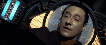 Movie still from “Star Trek: First Contact” (1996), directed by Jonathan Frakes – A man with a black jacket is looking into a mirror; Close Up shot, Overhead angle