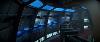 Movie still from “Star Trek: First Contact” (1996), directed by Jonathan Frakes – The interior of a ship with blue lights on it's walls; Wide shot, High angle