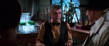 Movie still from “Star Trek: First Contact” (1996), directed by Jonathan Frakes – A man wearing a vest and a bow tie in a bar; Medium shot, Low angle