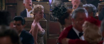 Movie still from “Star Trek: First Contact” (1996), directed by Jonathan Frakes – A woman in a leopard print dress standing next to another woman; Medium shot, Over the shoulder angle