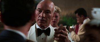 Movie still from “Star Trek: First Contact” (1996), directed by Jonathan Frakes – An older man wearing a tuxedo and bow tie; Close Up shot, Over the shoulder angle