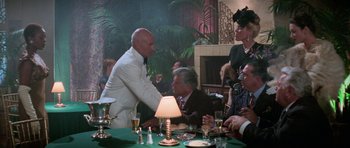 Movie still from “Star Trek: First Contact” (1996), directed by Jonathan Frakes – A man in a white suit shaking hands with a man in a brown suit; Medium shot, Over the shoulder angle