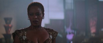 Movie still from “Star Trek: First Contact” (1996), directed by Jonathan Frakes – A woman in a gold dress is standing in front of a window; Close Up shot, Low angle