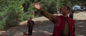 Movie still from “Star Trek: First Contact” (1996), directed by Jonathan Frakes – A man standing next to another man in a field; Medium shot, Over the shoulder angle
