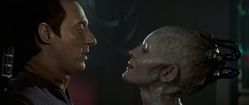 Movie still from “Star Trek: First Contact” (1996), directed by Jonathan Frakes – A man and a woman face to face in a dark room; Close Up shot, Over the shoulder angle