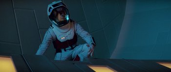 Movie still from “Star Trek: First Contact” (1996), directed by Jonathan Frakes – A person in a spacesuit and a helmet is sitting on a ramp; Medium shot, Low angle