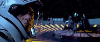 Movie still from “Star Trek: First Contact” (1996), directed by Jonathan Frakes – A man is looking out of a window at a space ship; Close Up shot, Over the shoulder angle