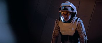 Movie still from “Star Trek: First Contact” (1996), directed by Jonathan Frakes – A man in a space suit with a helmet on his head; Medium shot, High angle