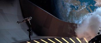Movie still from “Star Trek: First Contact” (1996), directed by Jonathan Frakes – A man standing in front of a wall with a view of the earth; Extreme Wide shot, Overhead angle