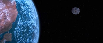 Movie still from “Star Trek: First Contact” (1996), directed by Jonathan Frakes – An image of an earth and a moon in space; Extreme Wide shot, Low angle