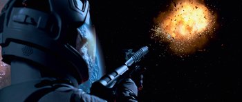 Movie still from “Star Trek: First Contact” (1996), directed by Jonathan Frakes – An image of a man shooting a gun in space; Medium shot, Overhead angle