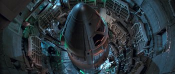 Movie still from “Star Trek: First Contact” (1996), directed by Jonathan Frakes – An aerial view of a space ship in a building; Extreme Wide shot, Overhead angle