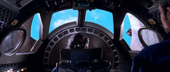 Movie still from “Star Trek: First Contact” (1996), directed by Jonathan Frakes – A person in a cockpit of an airplane looking out at the sky; Wide shot, Overhead angle