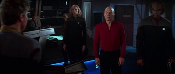A man and a woman standing next to each other in a room