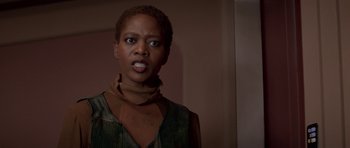 Movie still from “Star Trek: First Contact” (1996), directed by Jonathan Frakes – A woman standing in front of a wall with her mouth wide open; Close Up shot, Over the shoulder angle