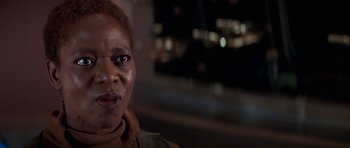 Movie still from “Star Trek: First Contact” (1996), directed by Jonathan Frakes – A person's face in front of a city skyline; Close Up shot, Low angle