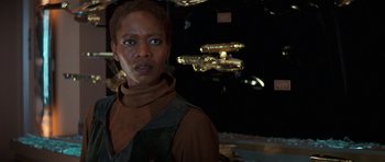 Movie still from “Star Trek: First Contact” (1996), directed by Jonathan Frakes – A woman standing in front of a mirror; Close Up shot, Over the shoulder angle