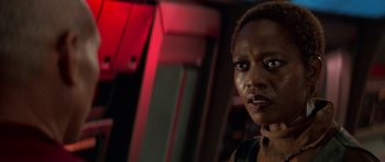 Movie still from “Star Trek: First Contact” (1996), directed by Jonathan Frakes – A person wearing a black shirt; Close Up shot, Over the shoulder angle