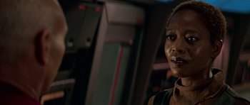 Movie still from “Star Trek: First Contact” (1996), directed by Jonathan Frakes – A person wearing a black shirt; Close Up shot, Over the shoulder angle