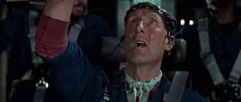 Movie still from “Star Trek: First Contact” (1996), directed by Jonathan Frakes – A man with a headset on is looking up at the sky; Close Up shot, Overhead angle