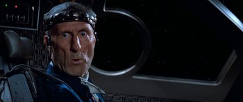 Movie still from “Star Trek: First Contact” (1996), directed by Jonathan Frakes – An old man with a funny face in front of a space background; Close Up shot, Low angle