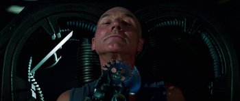 Movie still from “Star Trek: First Contact” (1996), directed by Jonathan Frakes – A bald man with a wrench in his mouth; Close Up shot, Low angle