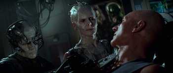 Movie still from “Star Trek: First Contact” (1996), directed by Jonathan Frakes – A woman with a bald head is looking at another woman; Close Up shot, Over the shoulder angle