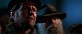 Movie still from “Star Trek: First Contact” (1996), directed by Jonathan Frakes – A man with a beard and a hat is looking at the camera; Close Up shot, Low angle