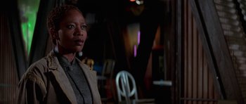 Movie still from “Star Trek: First Contact” (1996), directed by Jonathan Frakes – A woman standing in front of a chair in a room; Close Up shot, Low angle