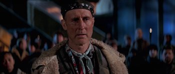Movie still from “Star Trek: First Contact” (1996), directed by Jonathan Frakes – An older man wearing a hat and a fur coat; Close Up shot, Over the shoulder angle