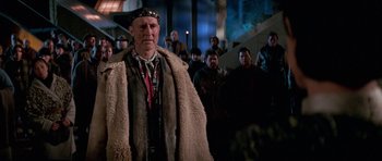 Movie still from “Star Trek: First Contact” (1996), directed by Jonathan Frakes – An older man wearing a fur coat and a hat; Medium shot, Over the shoulder angle