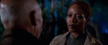 Movie still from “Star Trek: First Contact” (1996), directed by Jonathan Frakes – A woman in a brown jacket and a man in a tan jacket; Close Up shot, Over the shoulder angle