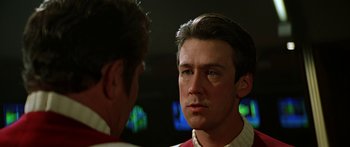 Movie still from “Star Trek: Generations” (1994), directed by David Carson – A man in a red and white shirt is talking to another man in a red shirt; Close Up shot, Over the shoulder angle