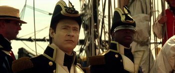 Movie still from “Star Trek: Generations” (1994), directed by David Carson – A man in a military uniform is standing next to another man in a military uniform; Close Up shot, Low angle