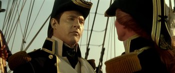 Movie still from “Star Trek: Generations” (1994), directed by David Carson – A man wearing a uniform and a hat on a boat; Close Up shot, Over the shoulder angle