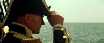 Movie still from “Star Trek: Generations” (1994), directed by David Carson – A person wearing a hat near a body of water; Close Up shot, Low angle