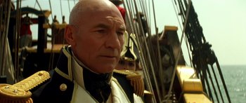 Movie still from “Star Trek: Generations” (1994), directed by David Carson – An older man wearing a uniform and a hat; Close Up shot, Low angle