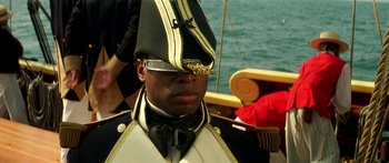 Movie still from “Star Trek: Generations” (1994), directed by David Carson – A man in a military uniform on a boat in the water; Close Up shot, Over the shoulder angle