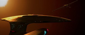 Movie still from “Star Trek: Generations” (1994), directed by David Carson – View of a space ship in the sky at night; Extreme Wide shot, Low angle