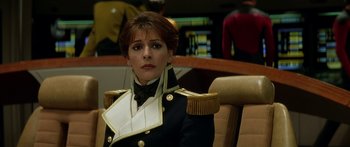 Movie still from “Star Trek: Generations” (1994), directed by David Carson – A woman in a uniform sitting in a chair; Close Up shot, Over the shoulder angle