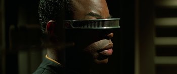 Movie still from “Star Trek: Generations” (1994), directed by David Carson – A man wearing a pair of glasses with a comb on top of his head; Close Up shot, Over the shoulder angle